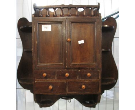 Edwardian stained pine hanging wall cabinet with an arrangement of shelves and drawers.(B.P. 24% incl. VAT)