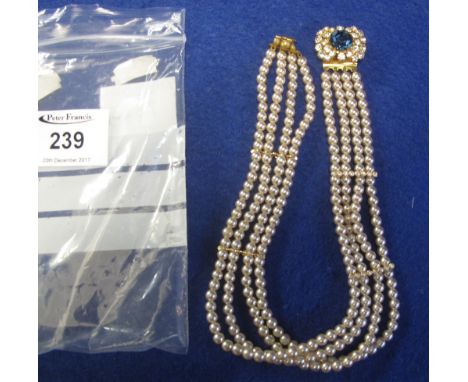 Pearl choker, having four rows and gem set clasp.(B.P. 24% incl. VAT)