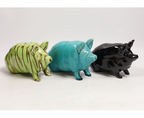 Three Wemyss style pigs in turquoise, pale green / brown and black glazes, one indistinctly marked W.. 15cm