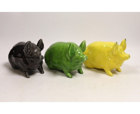 Three Wemyss ware  pigs in green, yellow and black glazes, 15cm
