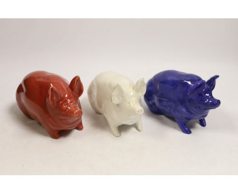 Three Wemyss ware pigs in cream, blue and pink glazes, 15cm