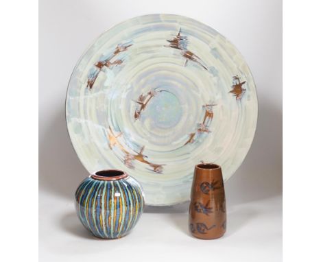 A Poole pottery lustre charger, initialled ‘MS’, 40cm and two vases with abstract designs, largest 40cm in diameter