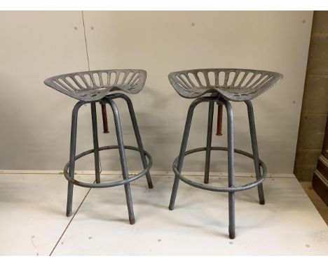 A pair of 'tractor seat' bar stools, width 50cm, height 68cm