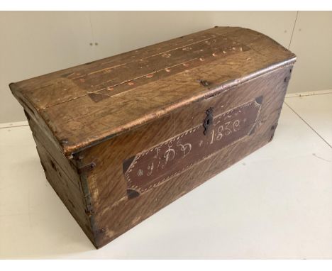 A 19th century pine domed top trunk with painted simulated grain initialled “I.P.D” and dated 1830, width 115cm, depth 53cm, 