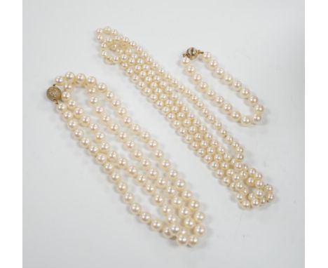 A single strand cultured pearl necklace, with diamond chip set 18ct gold clasp, 74cm and similar bracelet with diamond mounte