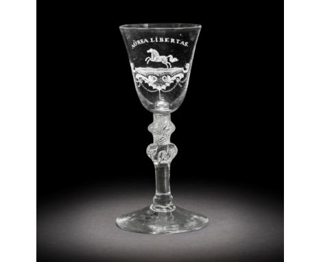 A fine Dutch engraved 'Liberty' light baluster wine glass attributed to Jacob Sang, circa 1760The round funnel bowl finely en