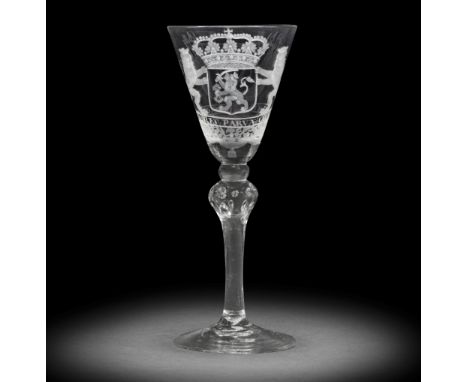 A rare Dutch engraved armorial 'VOC' light baluster wine glass, circa 1750The round funnel bowl with the crowned arms of the 