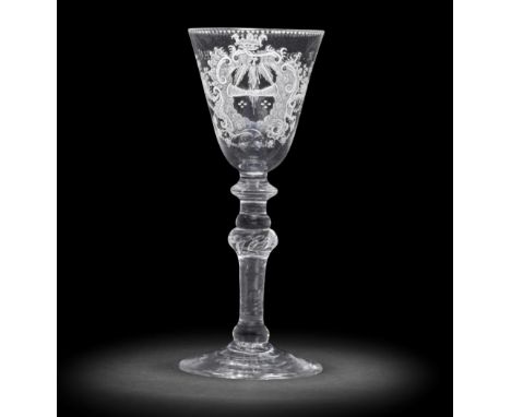 A Dutch engraved 'Friendship' light baluster wine glass, circa 1760The round funnel bowl with a pair of clasped hands emergin