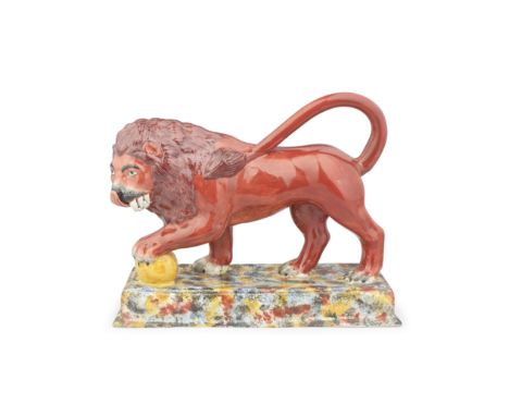 A large Staffordshire model of a Medici lion, circa 1820 Modelled standing on a rectangular base sponged in red, ochre, blue 