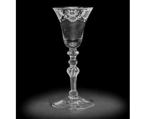 A Dutch engraved light baluster wine glass, circa 1760The bell bowl with an elaborate border of baskets of fruit alternating 