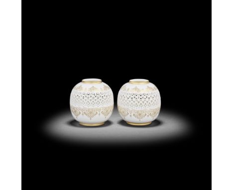 A pair of Royal Worcester reticulated vases by George Owen, dated 1917Of globular form, the middle sections pierced with a wi