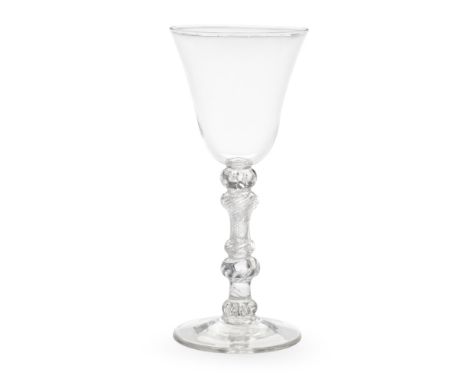 A most attractive composite stem light baluster goblet, circa 1750The generous round funnel bowl on an elaborate knopped stem