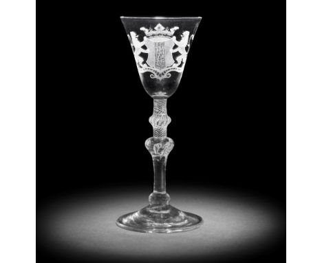 A good Dutch engraved armorial light baluster wine glass, circa 1760The round funnel bowl with the crowned arms of Delft flan