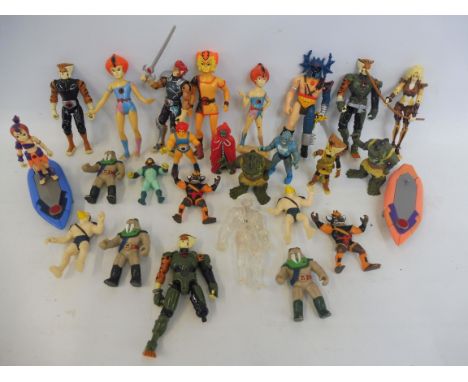 A tray of small scale He-Man and Thundercats action figures with some accessories.