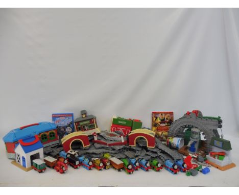 A quantity of Thomas the Tank Engine toys including diecast trains, carriages and track etc. 