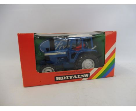 A boxed Britains 9523 Ford tractor, in original rainbow pack, VG condition.