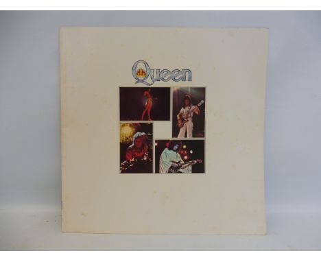 A circa 1977 Queen Tour Programme for The Earls Court, London also attached to the first page is the orginal ticket. 