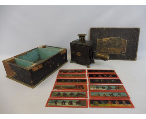 A pine cased table top magic lantern of tin and brass construction, bearing brass plaque E.R. Made in Germany, plus ten glass