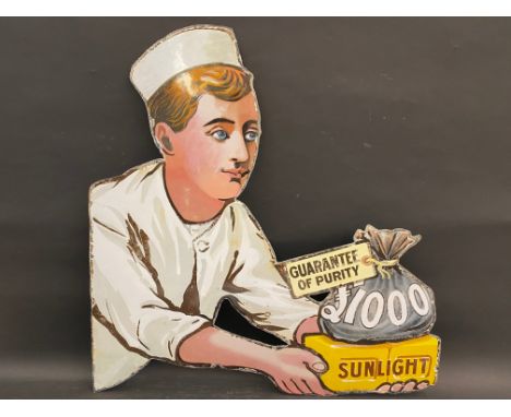A Sunlight Soap 'Guarantee of Purity' die-cut enamel sign in the form of a figure holding a bag of money, approximately four 