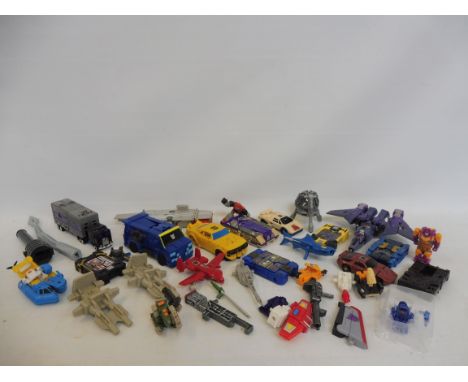 A box of mixed generation smaller scale Transformers, accessories and parts. 