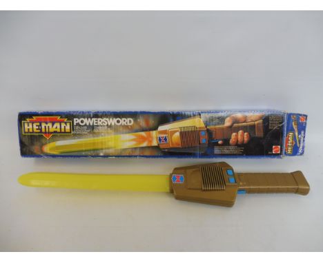 A boxed He-Man Powersword by Mattel. 
