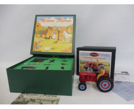 A boxed Britains home farm series 8705 farmyard set plus a David Brown 900 tractor.