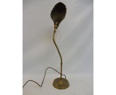 A brass adjustable table lamp with clam shell shade. 