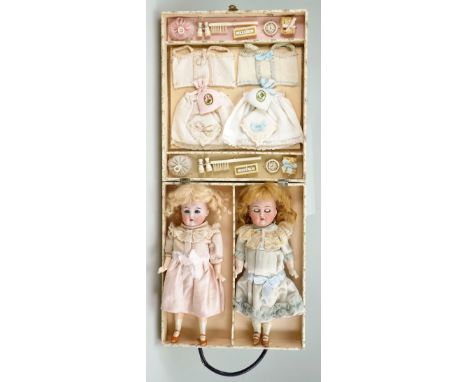 Pair of Kammer &amp; Reinhardt/S&amp;H bisque head dolls in case with layette, German circa 1910, each doll with weighted blu