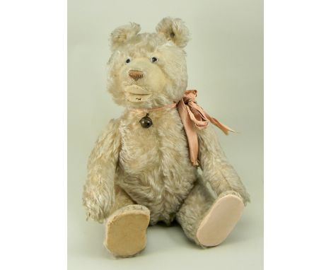 A Steiff white mohair Teddy Baby, 1930s, button to left ear, the straw stuffed bear with clear glass eyes, clipped mohair muz