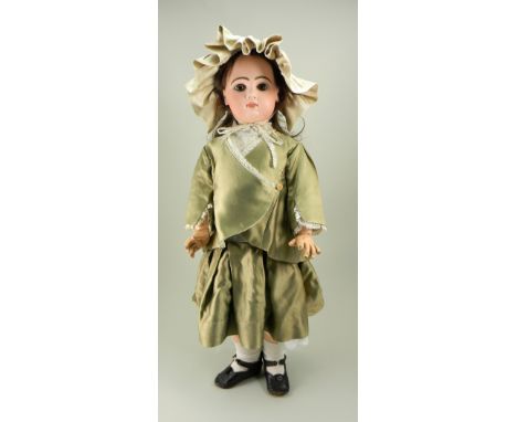 Large Tete Jumeau bisque head Bebe, French circa 1890, with fixed brown glass paper-weight eyes, painted lashes and feather b