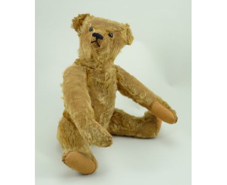 Steiff Teddy bear, German circa 1909, the straw filled golden mohair bear with black boot button eyes, pointed muzzle with bl