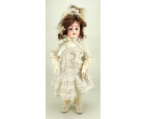 French bisque head doll, circa 1915, with fixed blue glass eyes, open mouth with upper teeth and brown wig, on a five piece c