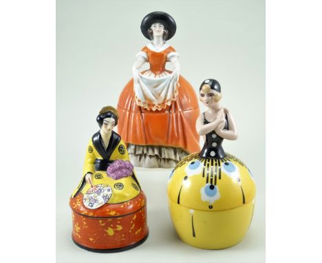 Three glazed china dressing table boxes, 1920s, including yellow circular box with black and blue decoration and Deco lady to