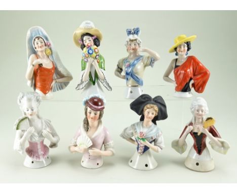 Eight glazed china half-dolls, including Goebels lady with brimmed hat with plume smelling a bunch of flowers, slight chip to