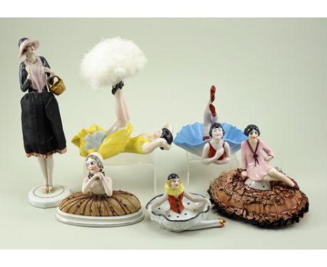 Collection of glazed china dressing table figurines, 1920s, full figure seated pin-cushion flapper in pink dress on frilly ma