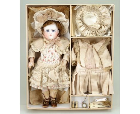 Rare size 3 Schmidt Bebe in presentation box with clothes and accessories, French circa 1880, with beautiful pale bisque roun