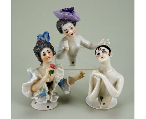 Three Dressel &amp; Kister glazed china half-dolls, child with finely painted features, grey hair and purple hat with bow, ou