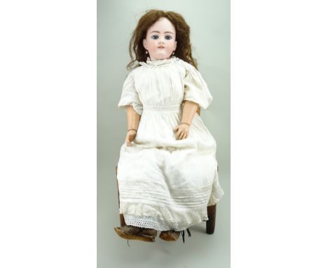 Large Handwerck bisque head doll, German circa 1910, with weighted blue glass eyes,open mouth with upper teeth, pierced ears 