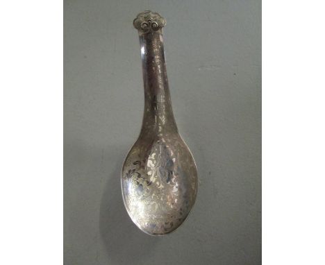 A Chinese silver rice spoon with floral engraved decoration and stylized finial, signed verso, 11cm long, weight, 20.5g 