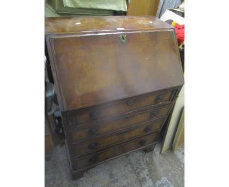 An early 20th century walnut bureau having a fall flap above four drawers and bracket shaped feet 101cm h x 72cm w 