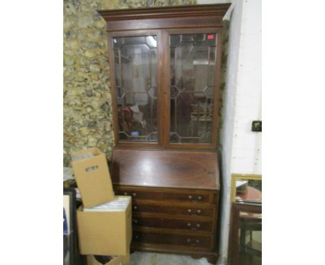 An inlaid mahogany Edwardian bureau bookcase, stepped pediment over twin astragal glazed display doors with adjustable intern