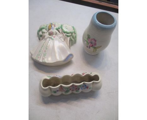 Clarice Cliff items comprising a posy trough, a vase and a wall pocket 