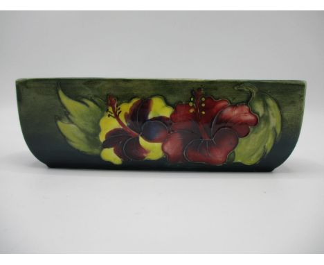 A Moorcroft Hibiscus pattern elongated trough decorated in purple, green and yellow, impressed Made in England 2.5" x 8" W, a