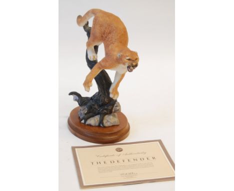 FRANKLIN MINT CHINA MODEL ' Defender' modelled as a Cougar about to leap from a branch, on an oval wood base, 11" (28cm) high