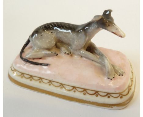 A CHAMBERLAINS, WORCESTER MODEL OF A RECUMBENT GREYHOUND, pink base, 3¼" (8.3cm) wide