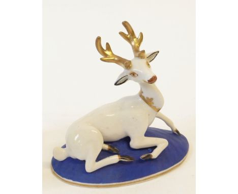 A CHARLES BOURNE MODEL OF A RECLINING STAG, gilt and black detail, dark blue and gilt oval base, underglaze initials C B in i
