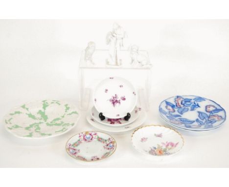 FIVE PIECES OF NYMPHENBURG PORCELAIN comprising: white glazed figure, 5 1/2" (14cm) high (as found); floral puce painted plat