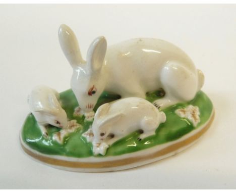 A CHAMBERLAINS, WORCESTER MODEL OF A RABBIT AND TWO YOUNG, green oval base, 3" (7.6cm) wide