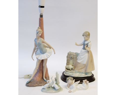 FOUR PIECES OF NAO PORCELAIN COMPRISING; a young GIRL beside a well, 11 1/2" (29.2cm) high, on wooden stand, Ballerina table 