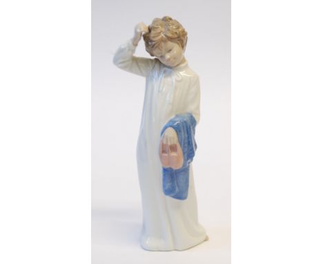 NAO PORCELAIN STANDING FIGURE OF A BOY IN NIGHT GOWN, holding slippers and towel, 11" (28cm) high